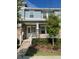 Charming two-story townhome with a cozy front porch and well-maintained landscaping in a suburban neighborhood at 8066 Glenlloyd Ave, Winter Garden, FL 34787