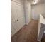 Upstairs hallway with neutral carpet, white trim, and multiple doors at 8066 Glenlloyd Ave, Winter Garden, FL 34787