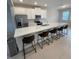 Modern kitchen with white cabinets, stainless steel appliances, and an island with seating for casual dining at 8066 Glenlloyd Ave, Winter Garden, FL 34787