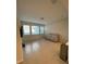 Spacious living room with tile flooring, a large window, and a comfortable couch for relaxing and entertaining at 8066 Glenlloyd Ave, Winter Garden, FL 34787