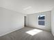 Well-lit bedroom with grey carpet and window at 812 Lockbreeze Dr, Davenport, FL 33897