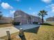 Two-story house with gray exterior, landscaping, and driveway at 812 Lockbreeze Dr, Davenport, FL 33897