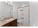 Well-lit bathroom featuring granite countertops, a vanity, toilet, and a unique patterned shower curtain at 9573 Meadow Hunt Way, Winter Garden, FL 34787