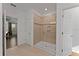 Modern bathroom with a glass-enclosed shower, tiled walls, and doorways at 9573 Meadow Hunt Way, Winter Garden, FL 34787