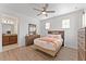 Bright bedroom with a ceiling fan, two windows, and a coordinating bedroom set at 9573 Meadow Hunt Way, Winter Garden, FL 34787