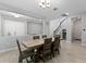 Open-concept dining room with modern lighting and easy access to kitchen and living room at 9573 Meadow Hunt Way, Winter Garden, FL 34787