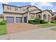 Charming two-story home boasts a three-car garage and a brick-paved driveway at 9573 Meadow Hunt Way, Winter Garden, FL 34787