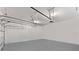 Spacious two-car garage features a clean, modern look with epoxy floors and plenty of room for storage and vehicles at 9573 Meadow Hunt Way, Winter Garden, FL 34787