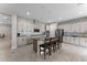 Stylish kitchen features an island with seating, stainless steel appliances, and sleek countertops and backsplash at 9573 Meadow Hunt Way, Winter Garden, FL 34787