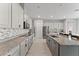 Modern kitchen features granite countertops, stainless steel appliances, a kitchen island with barstool seating and mosaic backsplash at 9573 Meadow Hunt Way, Winter Garden, FL 34787