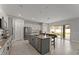 Bright kitchen boasts stainless appliances, granite countertops, and tiled backsplash with an eat in kitchen table at 9573 Meadow Hunt Way, Winter Garden, FL 34787