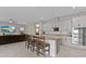 Modern kitchen with an eat-in island that opens to the living room at 9573 Meadow Hunt Way, Winter Garden, FL 34787