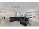 Spacious living room with a ceiling fan opens up to the modern, updated kitchen at 9573 Meadow Hunt Way, Winter Garden, FL 34787