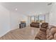 Spacious living room with hardwood flooring, comfortable seating, and plenty of natural light at 9573 Meadow Hunt Way, Winter Garden, FL 34787