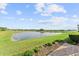 Relaxing view overlooking a tranquil pond with well-manicured landscaping and lush greenery at 9573 Meadow Hunt Way, Winter Garden, FL 34787