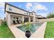 Backyard pool features a sun deck and is surrounded by a well-maintained lawn at 9573 Meadow Hunt Way, Winter Garden, FL 34787