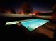 Relaxing nighttime view of a private pool and spa at 9573 Meadow Hunt Way, Winter Garden, FL 34787