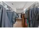 Spacious walk-in closet with ample storage, custom shelving, and hardwood flooring at 9573 Meadow Hunt Way, Winter Garden, FL 34787