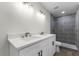 Modern bathroom with double vanity, quartz countertop, and grey tile shower at 1021 Flagler Ave, Edgewater, FL 32132