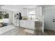 Newly renovated kitchen boasts white cabinets, stainless steel appliances, and a spacious layout at 1021 Flagler Ave, Edgewater, FL 32132