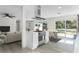 Open concept kitchen with island, stainless steel appliances, and access to backyard at 1021 Flagler Ave, Edgewater, FL 32132
