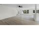 Spacious living area with large windows, wood-look floors, and a ceiling fan at 1021 Flagler Ave, Edgewater, FL 32132