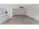 Bright living room with wood-look flooring and access to kitchen at 1021 Flagler Ave, Edgewater, FL 32132