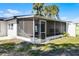 Screened porch offers shaded outdoor living space at 1021 Flagler Ave, Edgewater, FL 32132