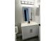 Stylish bathroom with a modern vanity, decorative mirror, and sleek fixtures at 1057 Inkberry Ct, Orlando, FL 32811