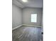 This bedroom features modern gray walls and gray laminate flooring at 1057 Inkberry Ct, Orlando, FL 32811