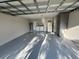 Spacious garage area with washer, dryer, water heater, refrigerator, cabinets and light gray epoxy flooring at 1057 Inkberry Ct, Orlando, FL 32811