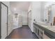 Spa-like bathroom with a walk-in shower, dual vanities, and stone accents at 13145 Paloma Rd, Clermont, FL 34711