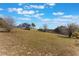 House exterior view with a large yard at 13145 Paloma Rd, Clermont, FL 34711