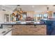 Modern kitchen with a brick accent wall, stainless steel appliances, and an island at 13145 Paloma Rd, Clermont, FL 34711