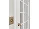 White french doors with golden hardware create a classic and elegant entryway feature at 1331 Common Way Rd, Orlando, FL 32814