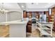 Bright, modern kitchen with stainless steel appliances, center island, ample counter space and tile flooring at 1331 Common Way Rd, Orlando, FL 32814