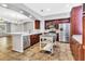 Spacious kitchen featuring stainless steel appliances, central island, and rich cabinetry at 1331 Common Way Rd, Orlando, FL 32814