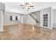 Inviting living room with tile flooring, staircase access, and neutral paint at 1331 Common Way Rd, Orlando, FL 32814