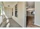 Inviting porch featuring white columns, a weathered wood floor, and views into the main living space at 1331 Common Way Rd, Orlando, FL 32814