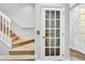Stairwell with white framed glass door at 1331 Common Way Rd, Orlando, FL 32814