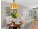 Well-lit dining area, wooden table, and four cushioned chairs at 1514 Doreen Ave, Ocoee, FL 34761