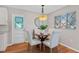 Charming dining area with a wooden table and four white chairs at 1514 Doreen Ave, Ocoee, FL 34761