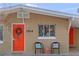 Bright orange front door with a stylish wreath at 1514 Doreen Ave, Ocoee, FL 34761