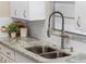 Modern kitchen features granite countertops, stainless steel sink, and a sleek gooseneck faucet at 1514 Doreen Ave, Ocoee, FL 34761