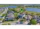 Aerial view of the property with a lake view and well-maintained landscaping at 15547 Hamlin Blossom Ave, Winter Garden, FL 34787