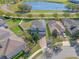 Aerial view of the property with a lake view and well-maintained landscaping at 15547 Hamlin Blossom Ave, Winter Garden, FL 34787