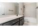 Bright bathroom featuring a bathtub, shower, and dark vanity at 15547 Hamlin Blossom Ave, Winter Garden, FL 34787