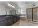 Modern bathroom with double vanity, granite countertops, separate shower and soaking tub at 15547 Hamlin Blossom Ave, Winter Garden, FL 34787