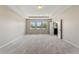 Spacious bedroom with plush carpeting and a view at 15547 Hamlin Blossom Ave, Winter Garden, FL 34787
