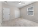 A serene bedroom features plush carpet, a ceiling fan, and a double closet at 15547 Hamlin Blossom Ave, Winter Garden, FL 34787